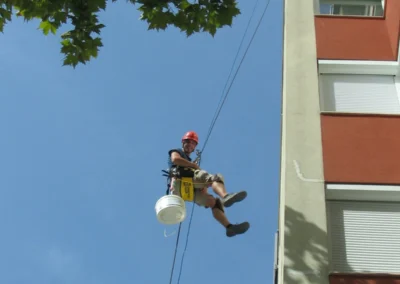 Ipari alpinista kötéllel ereszkedik le épület homlokzatán