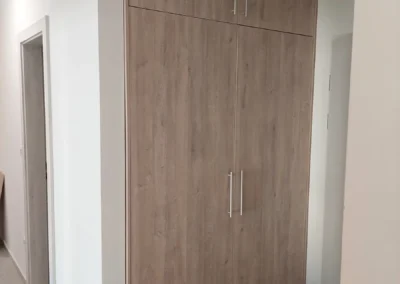 Magas beépített tárolószekrény fa hatású frontokkal